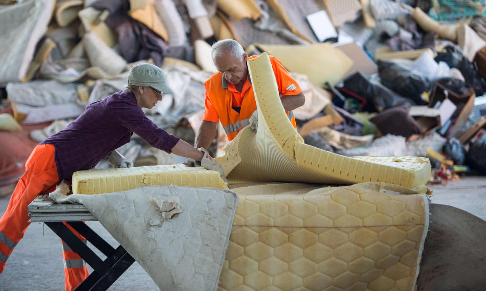 Workers sorting mattress's in the landfill